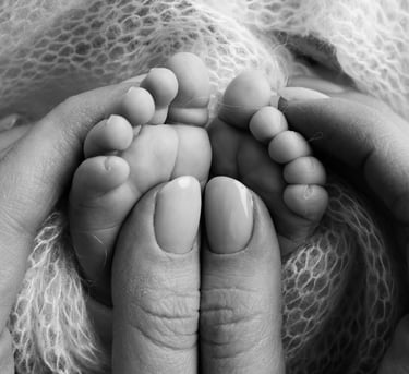 a baby's feet and toes are shown in this black and white photo