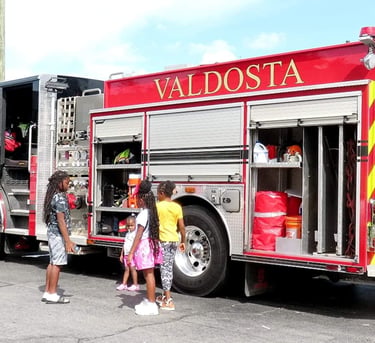 Girls at firetruck Reach Two event Brittany Woods Valdosta