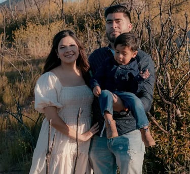 young Hispanic family in a field
