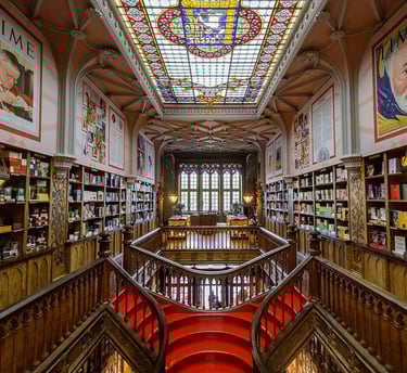 a staircase way with a red carpet and a skylight