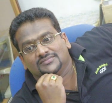 a man in a black shirt and glasses