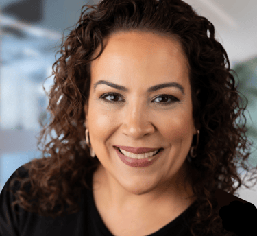 a woman with curly hair and a black shirt