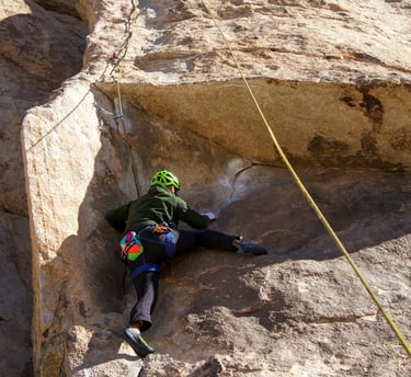 a person climbing a rock face on a rock face