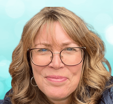 a woman with glasses and a blue jacket