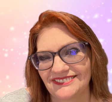 a woman with glasses and a grey shirt
