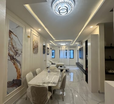 Aménagement intérieur complet avec grande table à manger et décoration murale artistique