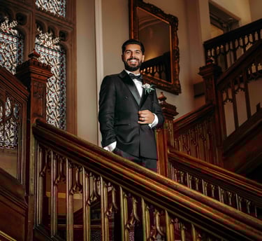 Groom portrait on elegant wooden staircase – classic Oxford wedding photography by Fred Art Studio