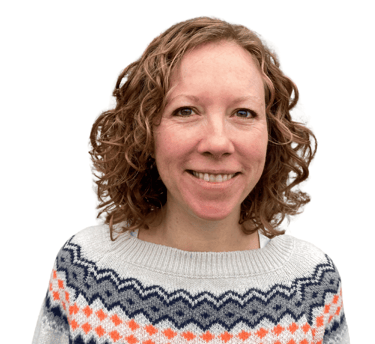photo of Iona Reading, Health Coach. Iona is wearing a grey jumper with a blue and orange pattern.
