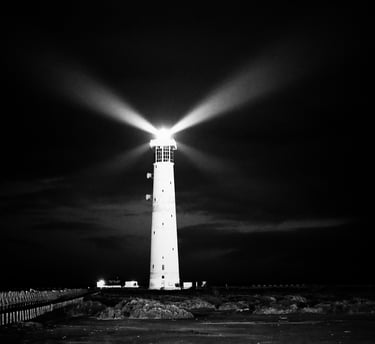 a lighthouse at night with a bright light shining from it