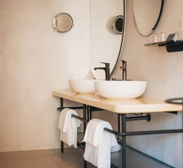 a bathroom with a sink and a mirror in a hotel.Market Positioning for Tourism with Timea Pokol