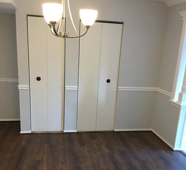 Dark wood-look vinyl plank flooring installed in dining area.