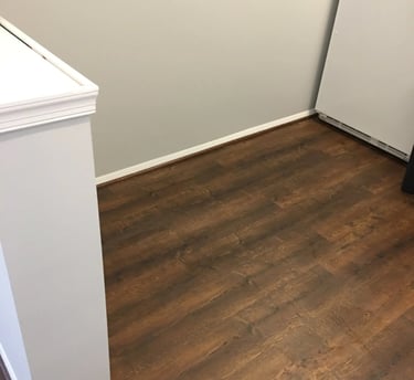 Dark wood-look vinyl plank flooring installed in kitchen.
