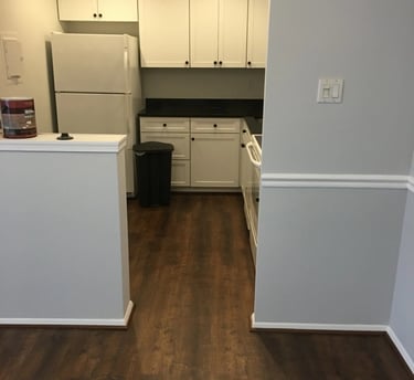 Dark wood-look vinyl plank flooring installed in kitchen.