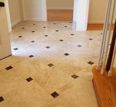 professionally installed polished marble tiles accented with contrasting dark inlays.