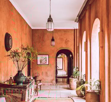a welcome hallway with a large rug and a wooden table at reception. Guest Experience Enhancement