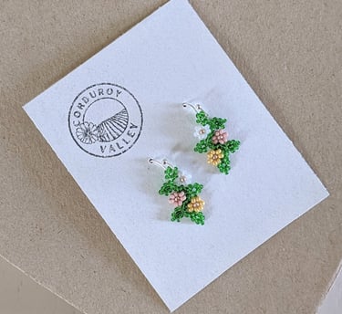 Beautifully hand beaded soft pink, soft mustard, and pearl white floral garland earrings made with Czech glass beads