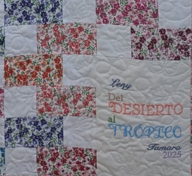 Floral block quilt with meandering butterfly quilting and a personal message embroidered in corner