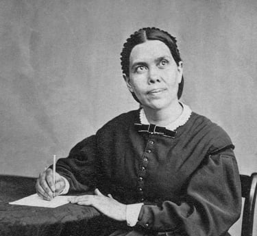 Black and white picture of Ellen G. White writing on a paper