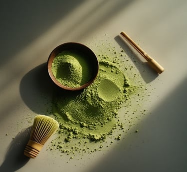 Matcha bowl and bamboo whisk with green powder on a white background.