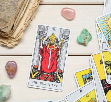 The Hierophant tarot card on a stack with crystals for tarot study and learning.