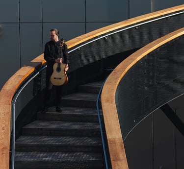 Classical Guitarist Filip Babic standing on stairs outside