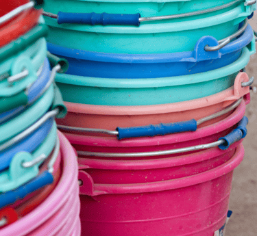 a bunch of buckets with different colored plastic buckets