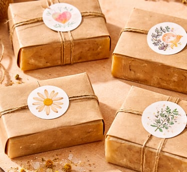 Handmade soap fully wrapped in brown kraft paper, sealed with a round “handmade” stamp