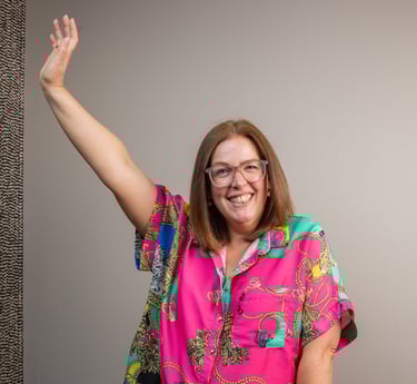 photo of gabi founder of the leopard mind smiling with arm in the air 