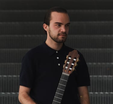 Classical guitarist Filip Babic standing with the guitar casual
