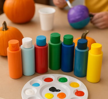painting supplies on a craft table with bottles of acrylic paint