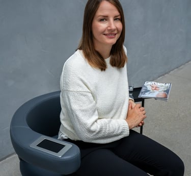 a woman sitting in a chair with a magazine on it