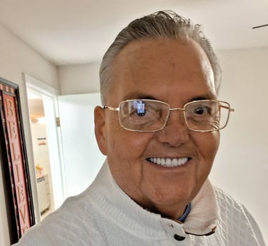 a man in a white shirt and glasses