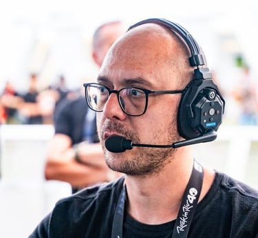 a man with a headset and a microphone in front of a microphone