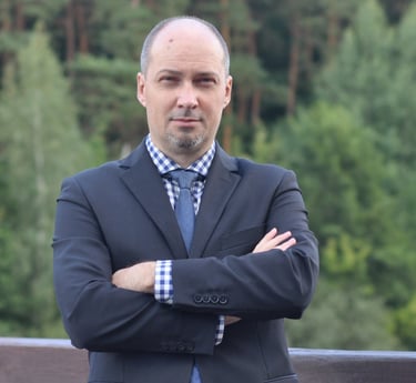 a man in a suit and tie standing on a bridge