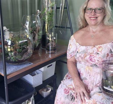 a woman in a floral dress sitting on a shelf