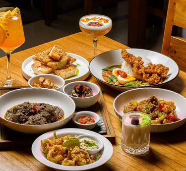 a table with plates of food and drinks