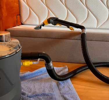 a couch with a vacuum and a vacuum