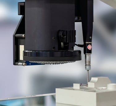 Micro-Vu optical CMM performing a CMM touch probe on a machined part.