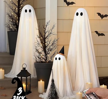 Set of three light-up Halloween ghost decorations with white draped fabric, black eyes, and remote c