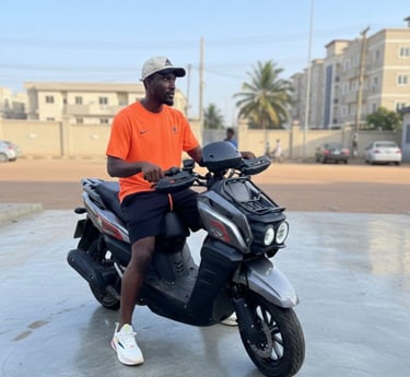 Young man in orange t-shirt on an electric bike