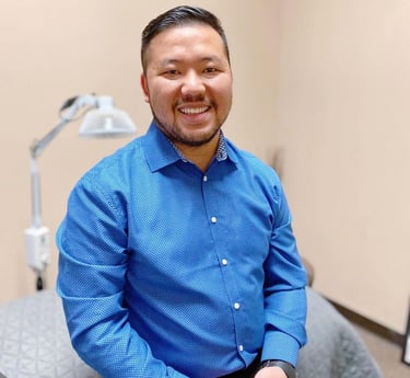 Dr. Xiong in a blue button-down shirt at Balance Naturopathic & Acupuncture Clinic.