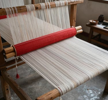 Artisan hand-weaving vibrant traditional fabrics in a sunlit rural workshop.