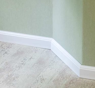 Baseboard trim covering the edge gap between wall and flooring.