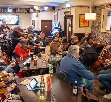 Scottish folk music players in a pub setting