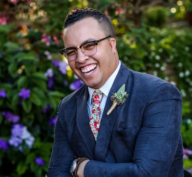 a man in a suit and tie smiling