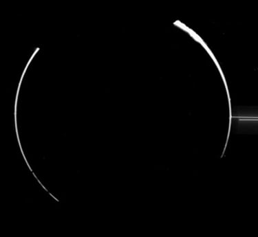 a black and white photo of a ring around the moon