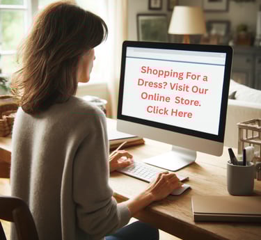 a woman sitting at a desk with a computer screen displaying a dress
