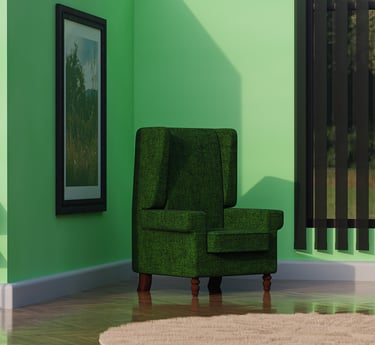 a green armchair in a green room with a table and picture