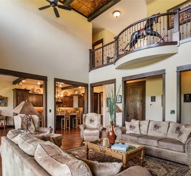 Furnished living room in custom luxury home with custom wood rails and trim in MT