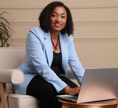Beverly Vanterpool., sitting at a table with a laptop, Building her Table